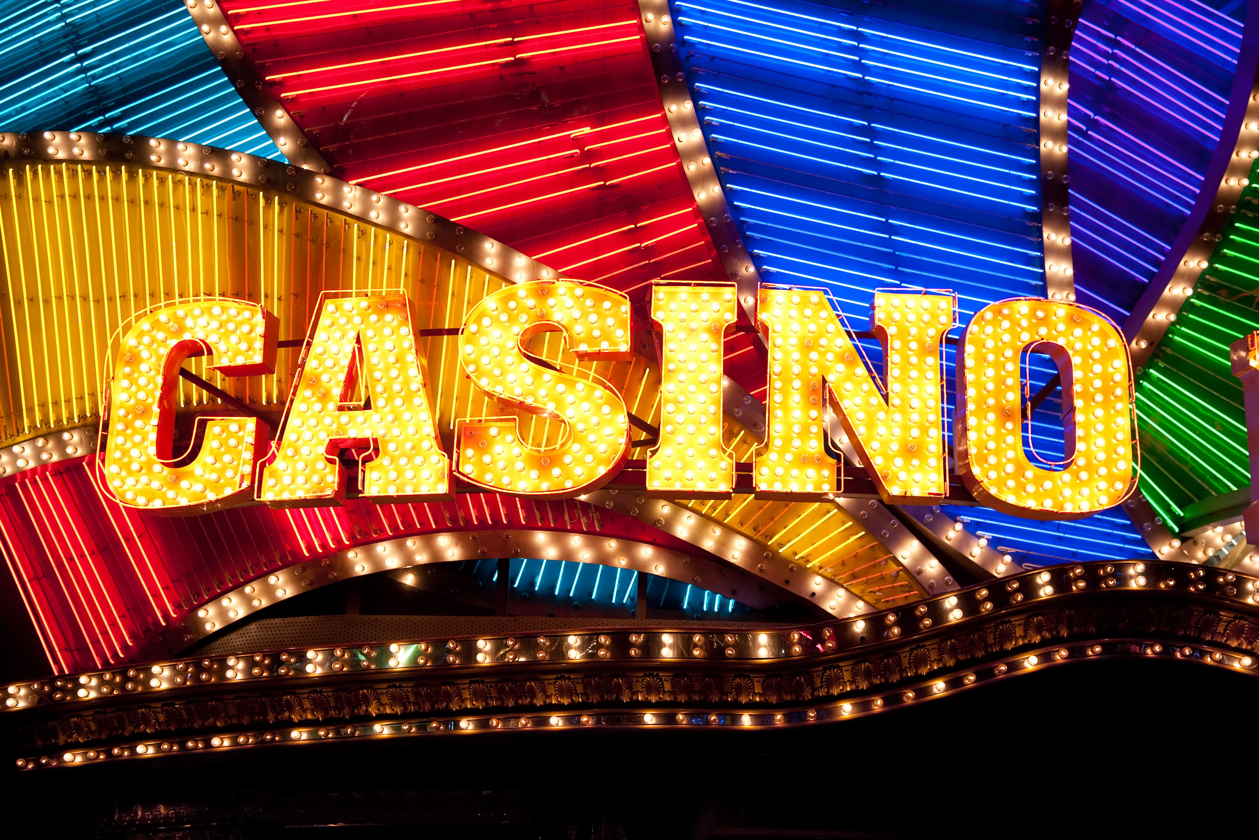 A vibrant graphic showcasing the Jackpot Wins logo and a cascade of gold coins.